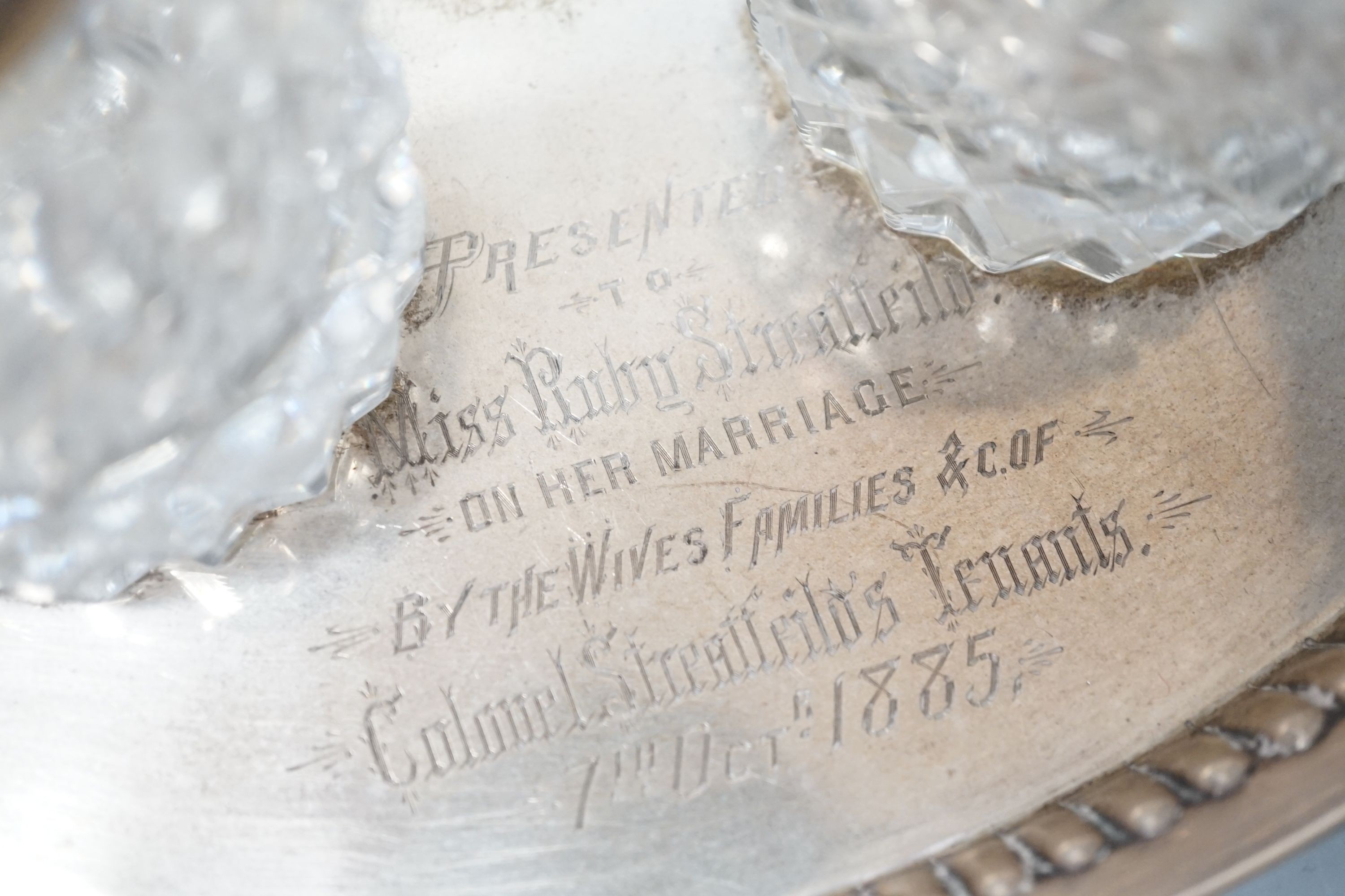 A presentation silver oval inkstand, with two mounted glass wells, William & John Barnard, London, 1884, ‘presented to Miss Ruby Streatfeild’, (a.f.),24.1cm and one other silver inkstand, Charles Stuart Harris, London, 1